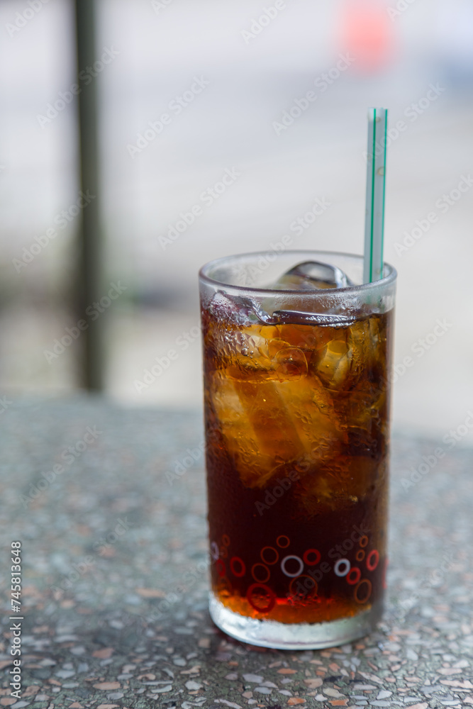 Cola with crushed ice and a straw in a clear glass is ready to drink to quench your thirsty Cola with crushed ice and a straw in a clear glass is ready to drink to quench your thirsty