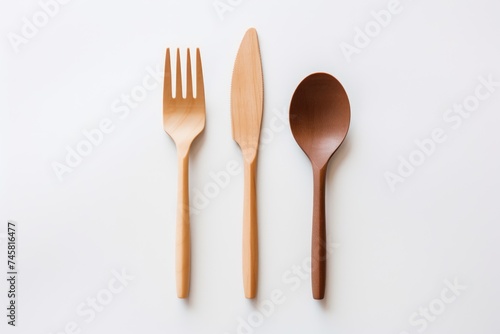 A set of wooden fork, knife, and spoon representing sustainable living. Biodegradable Wooden Cutlery Set on White