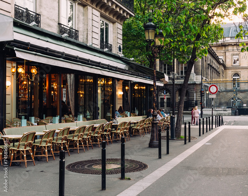 Cozy street with tables of cafe in Paris, France. Cityscape of Paris. Architecture and landmarks of Paris.