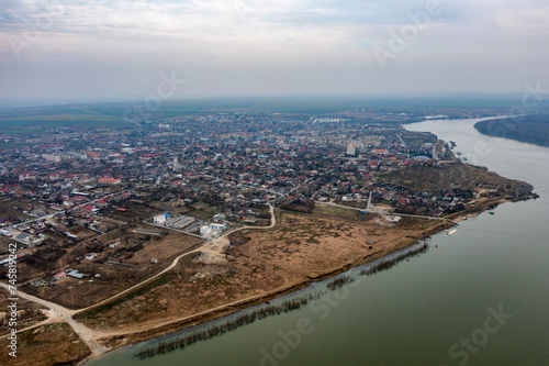 Riverside Urban Charm: Aerial View of Danube City Shoreline In Romania