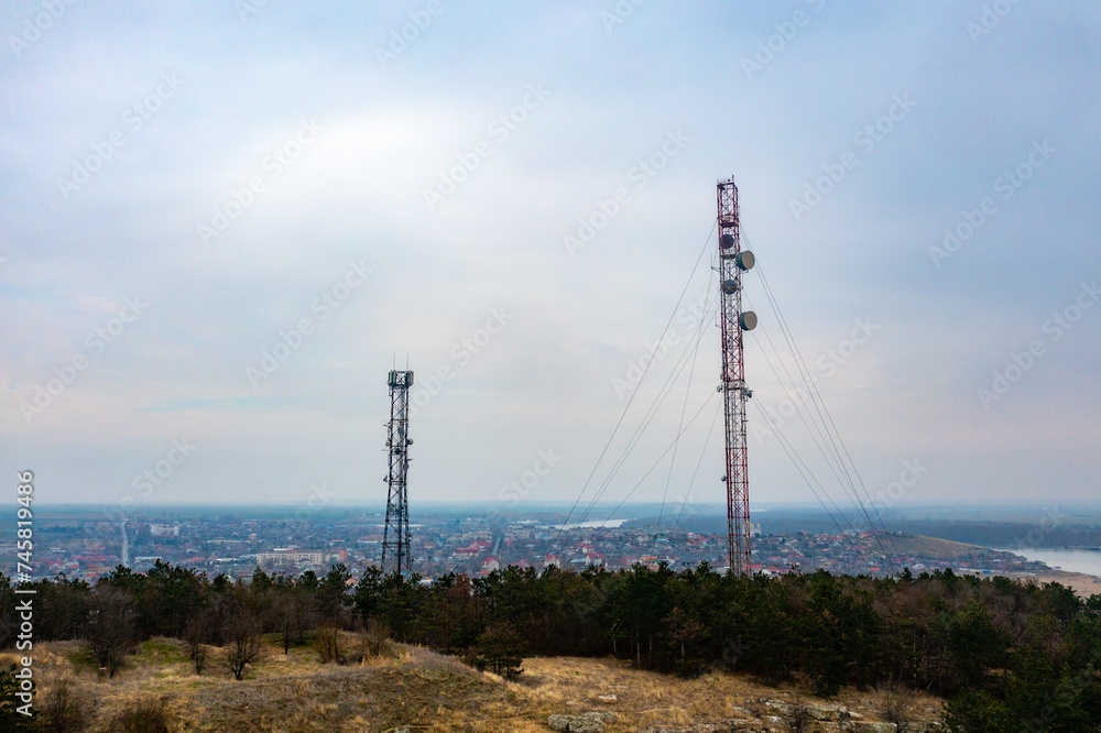 Silent Guardian: Aerial View of Mobile Tower Amidst Romanian Woodlands, Overlooking Danube City Silent Guardian: Aerial View of Mobile Tower Amidst Romanian Woodlands, Overlooking Danube City