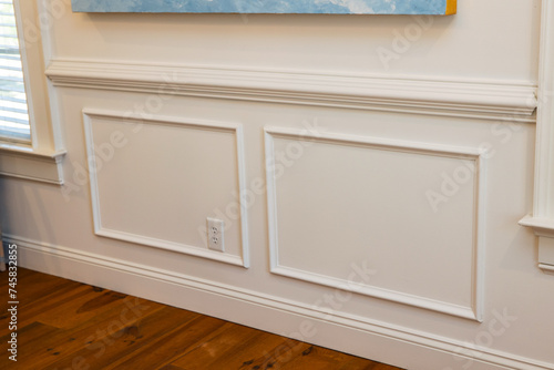 Cream colored architrave decorative wall molding wall trim with skirting and panels in the interior of an old home house photo