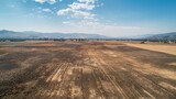 Aerial view of once-fertile farmland transformed into a mosaic of desolation by relentless drought conditions