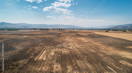 Aerial view of once-fertile farmland transformed into a mosaic of desolation by relentless drought conditions