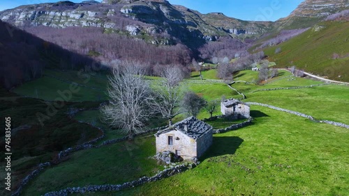 Autumn landscape of meadows, pasiegas cabins and deciduous forest seen from a drone. The Machorras. Pasiegos Valleys. Burgos. Castile and Leon. Spain. Europe photo