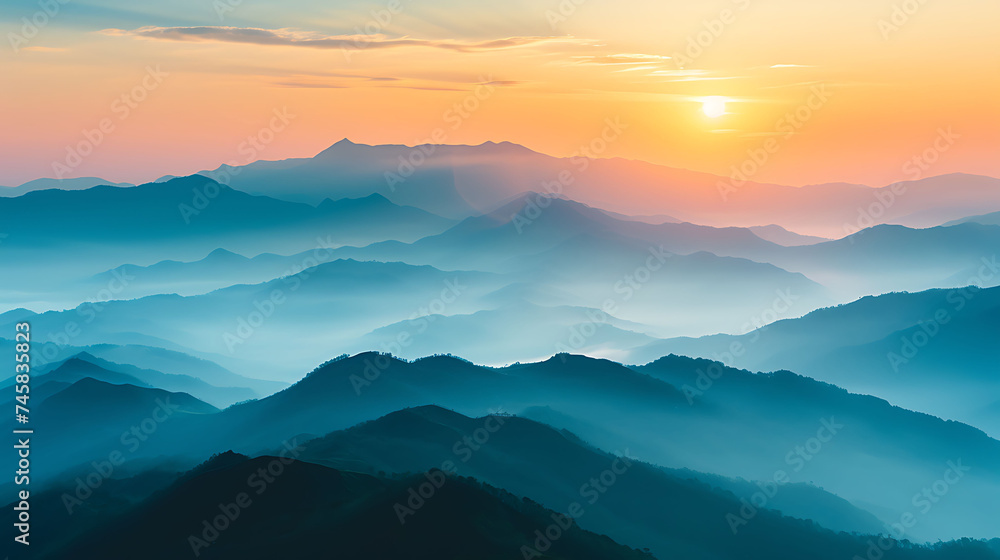 Sunrise over a mountain range with misty valleys. Copy Space