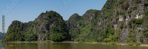Panoramic views of Ninh Binh Countryside with Green mountains, blue skies and rice fields in Vietnam