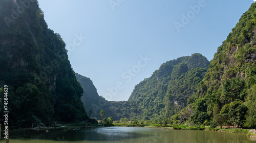 Landscape Orientation of Green Mountain views of Tam Coc in the Ninh Binh Region of Vietnam