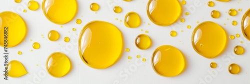 Macro photography close up of yellow liquid drops oil on a white background