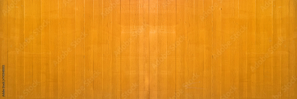 Fototapeta premium Abstract yellow painted colored stone concrete cement board texture wall wallpaper tiles background panorama banner