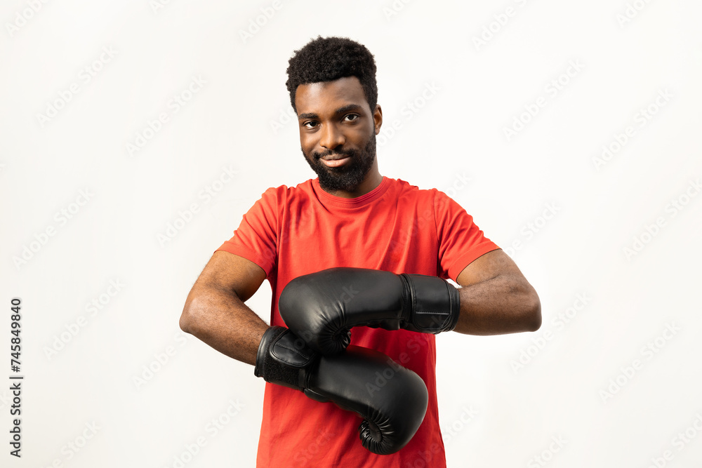 Portrait of a confident African American man wearing boxing gloves, ready for training. Isolated on white, this image conveys determination, strength, and a healthy lifestyle.