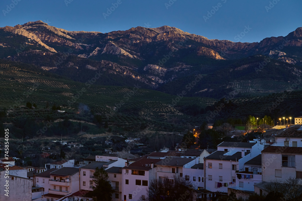 View of medieval Spanish city Quesada in province of Jaen in Andalusia, illuminated with street lights in the evening.