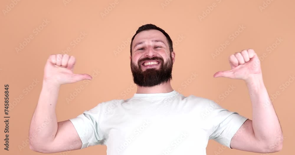 Excited bearded man pointing at self isolated on beige background. Pick me concept. Excited bearded man pointing at self isolated on beige background. Pick me concept.