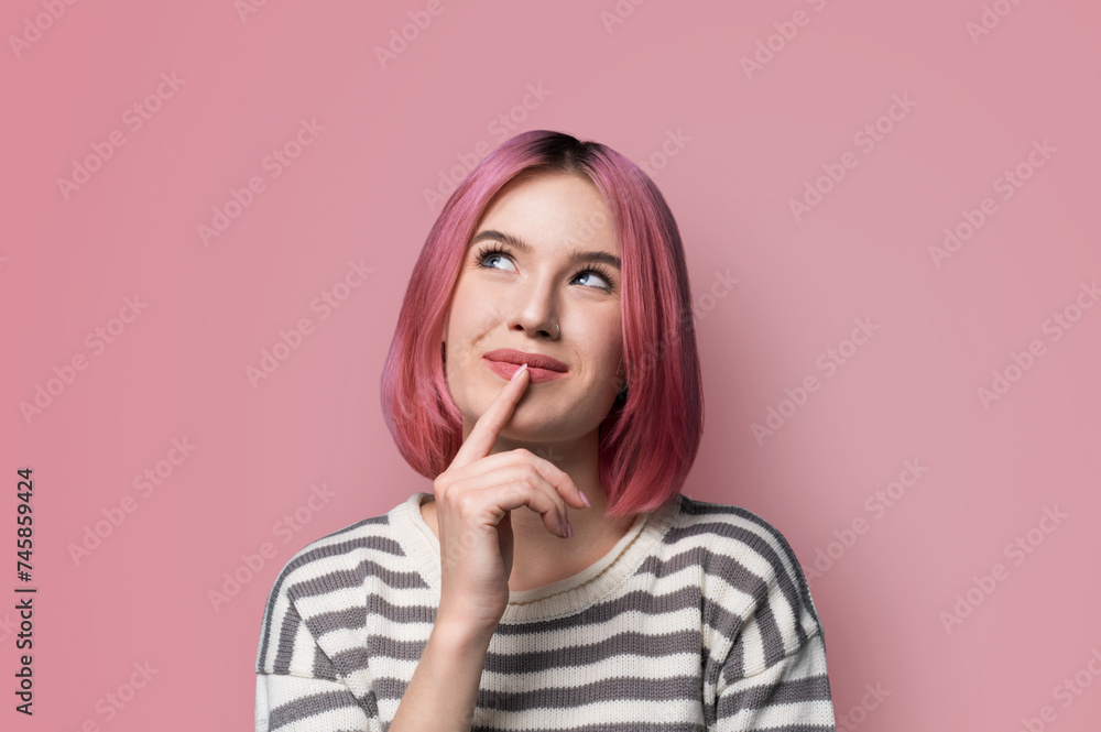 Portrait ad image - mysteriously grinning smile look up thinking gladly pink hair haired woman wear grey striped sweater jumper, hold finger over her she lips, isolated pastel studio wall background. Portrait ad image - mysteriously grinning smile look up thinking gladly pink hair haired woman wear grey striped sweater jumper, hold finger over her she lips, isolated pastel studio wall background.
