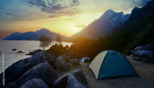 Camping on the lake beach in the forest, at the sunset.