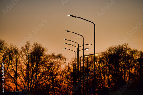 sunset in the countryside with street lanterns