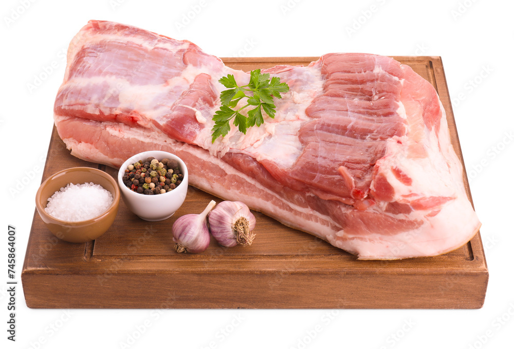 Piece of raw pork belly, parsley, garlic and spices isolated on white