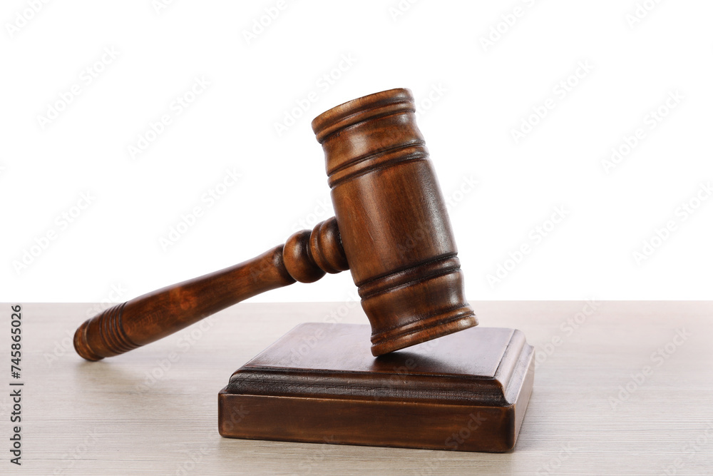 Wooden gavel on light table against white background Wooden gavel on light table against white background