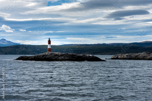 end of the world lighthouse in ushuaia argentina on an island of rocks in the beagle channel © Alejandro Piorun