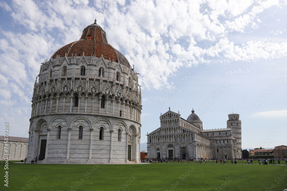The Pisa Baptistery of St. John, The Cathedral and The Leaning Tower of Pisa in Square of Miracles, Tuscany , Italy.