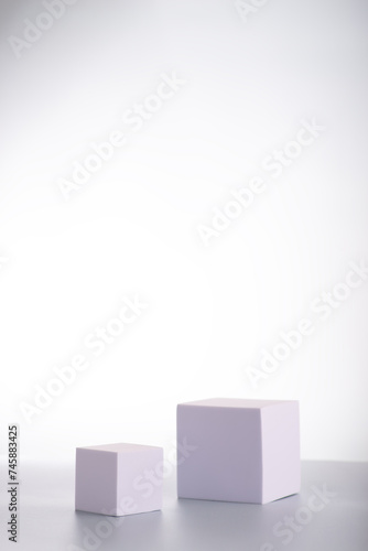 White square podiums in sunlight with shadow on white background. Trend fashion showcase