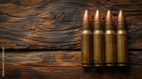 Military firepower: Cartridges for a rifle and a carbine on a wooden background. Ammo close-up. Space for text 