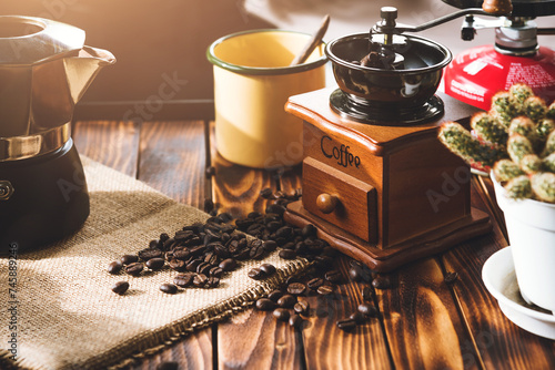 Cup Of Coffee, beans roating and Ingredients for making coffee and accessories on the table wooden background. Coffee making concept photo
