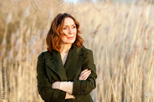 portrait of middle aged woman posing at the park