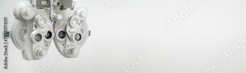 ophthalmology banner with copyspace close up of phoropter, specialized instrument used in eye examinations to measure refractive errors and determine eyeglass prescriptions, eye medical clinic