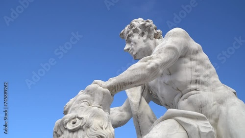 Close view on white stone statue of Hercules fighting a lion in Karlsruhe Germany
