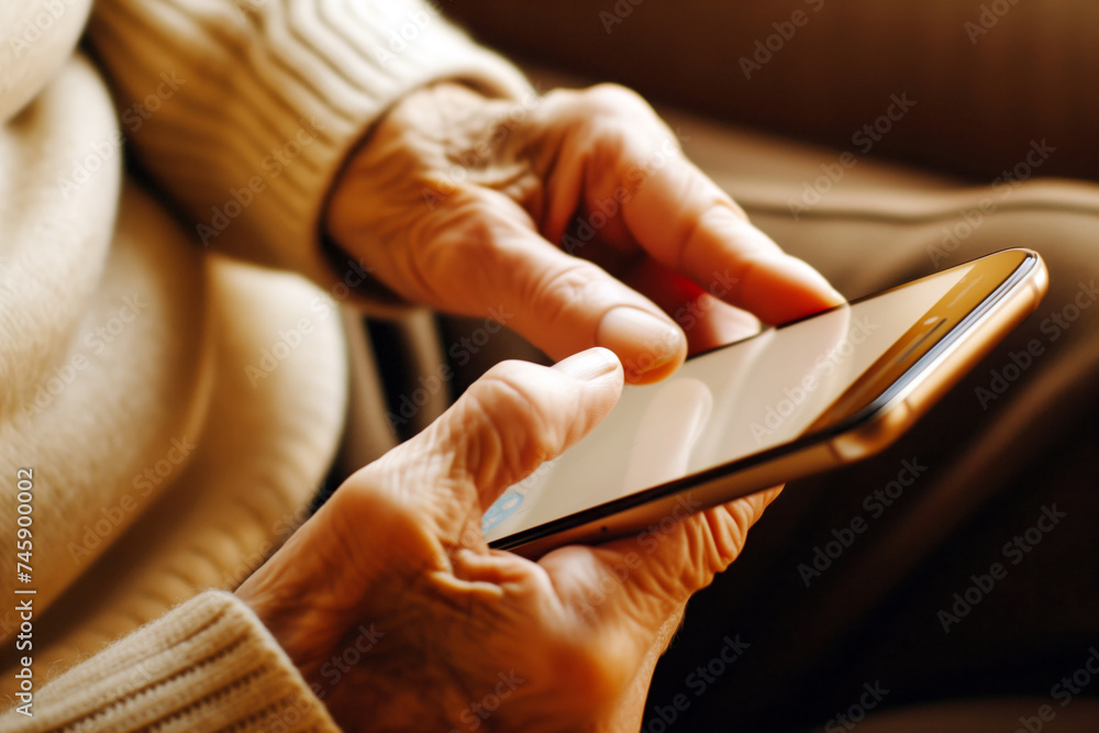 mature individual using a smartphone, focusing on fingers and screen