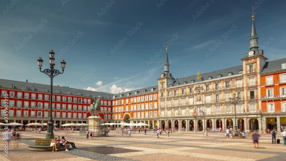 MADRID, SPAIN - FEBRUARY 19, 2024: Timelapse hyperlapse at Mayor plaza in Madrid in a beautiful sunny day with cloudy sky. Famous touristic landmark in old historical city center. MADRID, SPAIN - FEBRUARY 19, 2024: Timelapse hyperlapse at Mayor plaza in Madrid in a beautiful sunny day with cloudy sky. Famous touristic landmark in old historical city center.