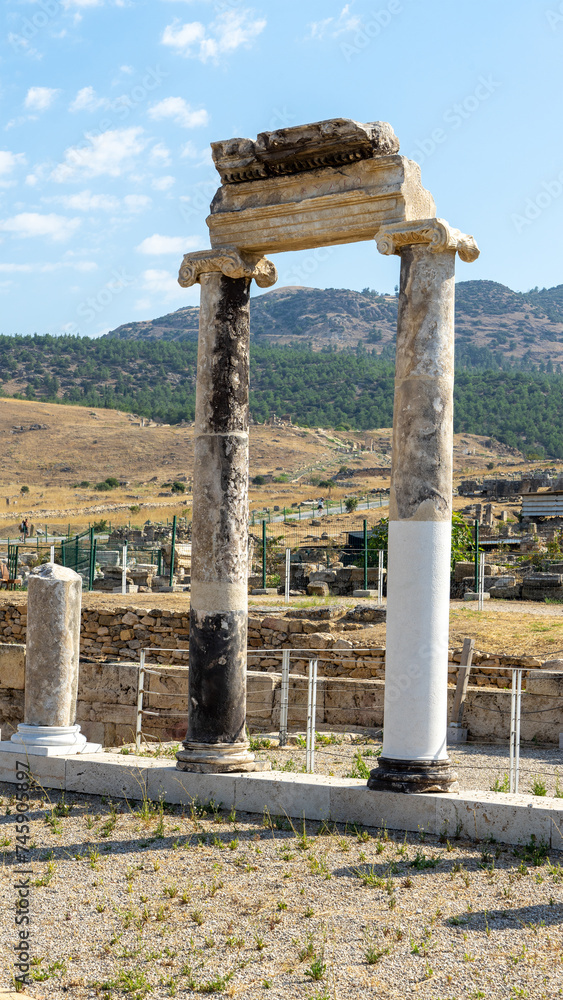 Restored columns in ancient city Hierapolis near of Pamukkale or Cotton Castle. Phrygian cult center. Vertical image