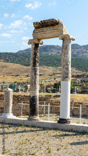 Restored columns in ancient city Hierapolis near of Pamukkale or Cotton Castle. Phrygian cult center. Vertical image