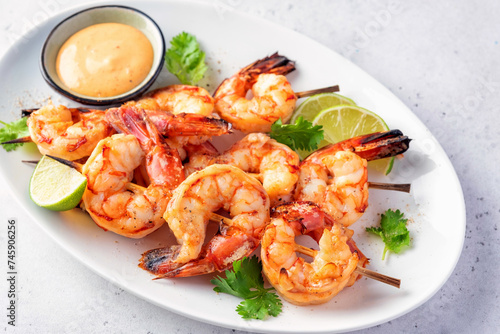 Grilled shrimps. Shrimps skewers, lime and fresh herbs