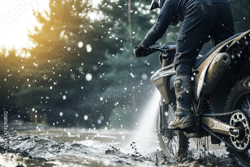 man washing mud off an offroad motorcycle photo