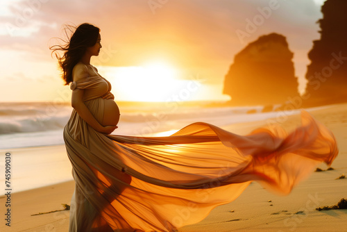 pregnant lady in a flowing dress on a beach at sunset