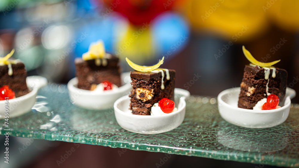 Small pieces of various tasty cake, there are placed on the international buffet meal. Sweet dessert food object photo, Close-up and selective focus.