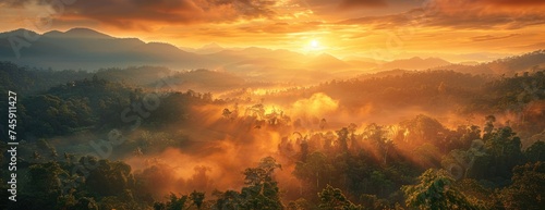 Majestic Mountain Sunrise: Ablaze Sky Casting Radiant Glow Over Dense, Mist-Enveloped Forest