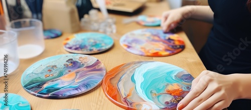 Artistic Creation: Young Woman Painting One-of-a-Kind Coasters on a Ceramic Plate