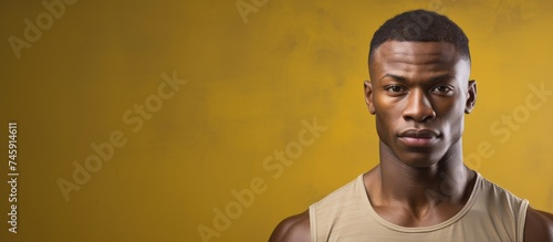 Confident African American Man Posing with Yellow Background in Casual Attire