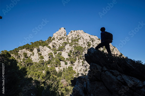 silhouette of a hiker in front of Puig d en Grau  867 m   Escorca  Mallorca  Balearic Islands  Spain