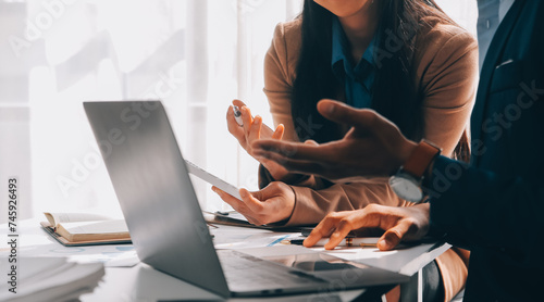 Business team working with new startup project plan and discussion information for financial strategy with laptop and digital tablet in a modern business lounge.