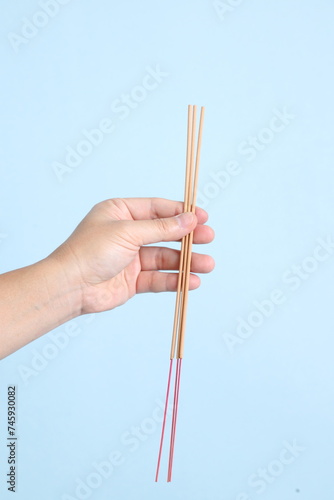 hand holding the incense sticks