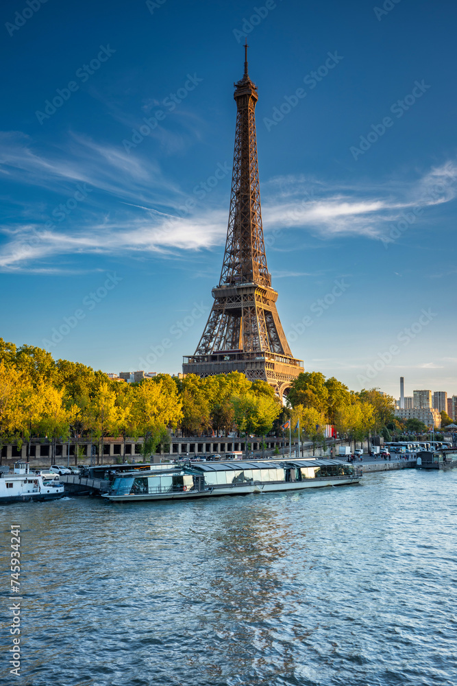Fototapeta premium Eiffel Tower by the Seine River in Paris at summer. France