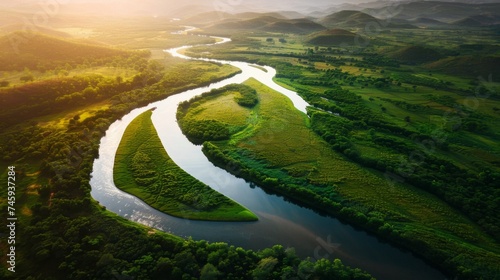 Aerial view of a meandering river through vibrant green wetlands at sunset photo