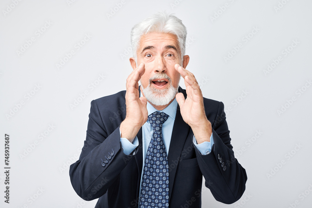 Portrait of senior businessman in suit shouting loudly with hands, news, palms folded like megaphone isolated on white background. Portrait of senior businessman in suit shouting loudly with hands, news, palms folded like megaphone isolated on white background.