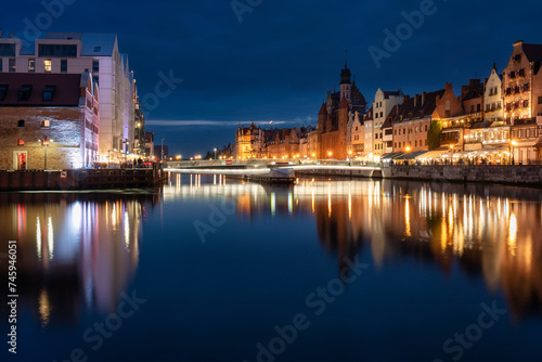 Old town in Gdansk with historical architecture by the Motlawa river at night, Poland.
