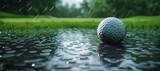 Golf ball resting on wet grass with water pooled around, under rainy weather conditions