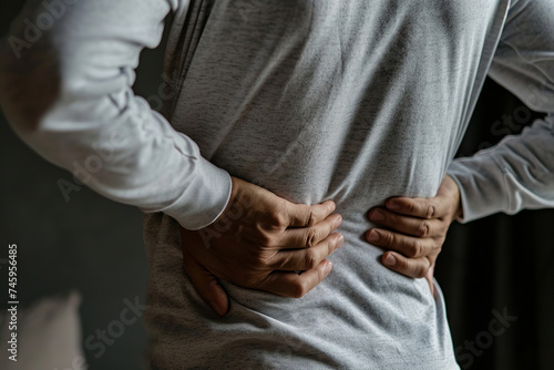 Back pain, close up young man has injury during outdoor exercise. Elderly and health issues concept. Medical concept.